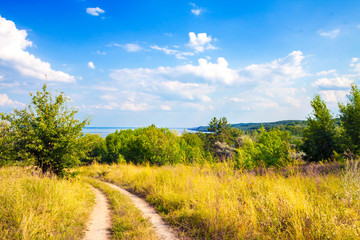 Beautiful landscape of Kaniv Reservoir shore, Ukraine, in sunny day with bright cloudy sky