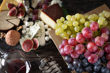 Red wine in the bottle and in the glass with appetizer
