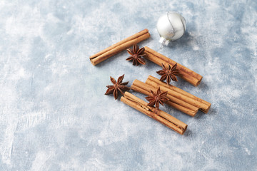 Star anise with cinnamon. Christmas spices on bright wooden background. Copy space. 