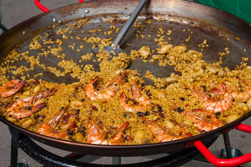 Cooking Spanish Seafood Paella in Traditional Pan