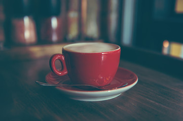 Cup of cappuccino coffee on wooden table