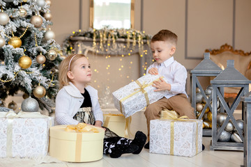 Little kids friendship and love. Little boy giving a little girl a gift. Present for a birthday,...