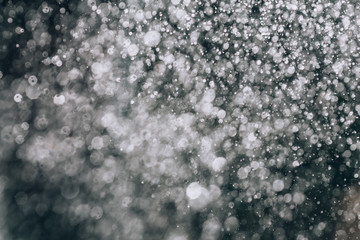 Rain. Beautiful rain background. Abstract rain texture closeup. Raindrops on a black background.