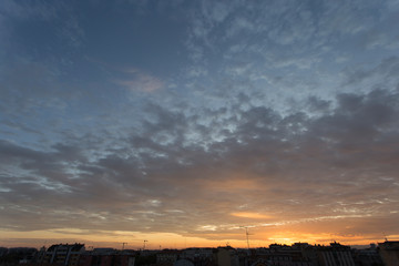 Colourful sunset over a dark city