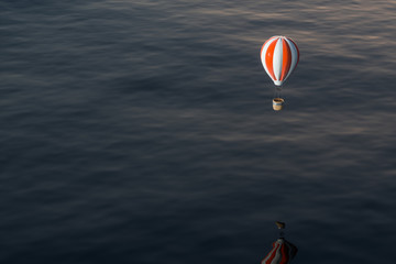 Hot air balloon flying over the ocean, 3d rendering.