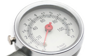 Pressure gauge for measuring air pressure in car tires on a white background