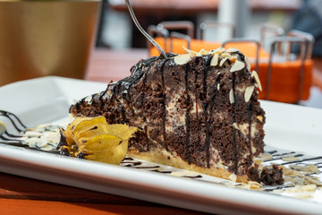 sweet chocolate cake on a wooden table in a cafe
