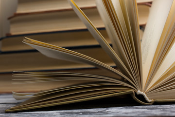 Open book, hardback books on wooden table. Back to school. Copy space