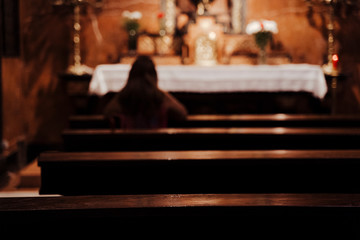 unrecognizable Woman Sitting in Church praying. Religion Concept. Back view