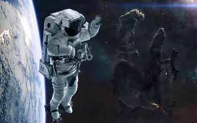 Pillars of Creation, astronaut, planet in deep space. Science fiction. Elements of this image furnished by NASA