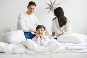 A beautiful young family in the morning bedroomis relaxing and have a fun on a white background