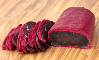 Fototapeta premium Cured meat on a wooden board. Close-up of basturma sliced into pieces.