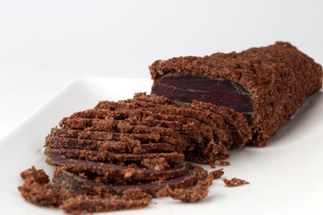 Jerky on a white background. Close-up of basturma sliced into pieces.
