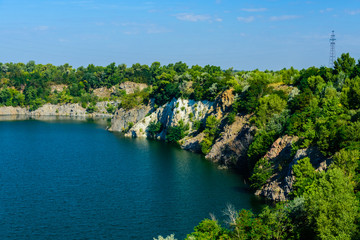 Fototapeta premium Beautiful lake in the abandoned granite quarry on summer