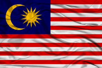 beautiful photo of the national flag of Malaysia on delicate shiny silk with soft draperies, the concept of state power, country life, horizontal, close-up, copy space