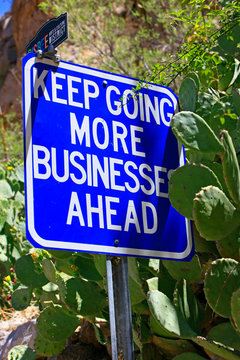 Keep Going More Businesses Ahead blue and white sign in Bisbee, AZ