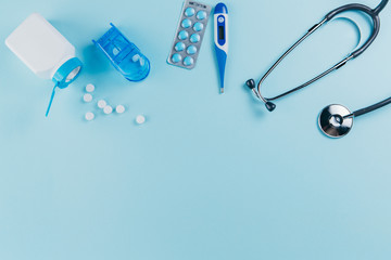 Medical equipment and pills on a blue background