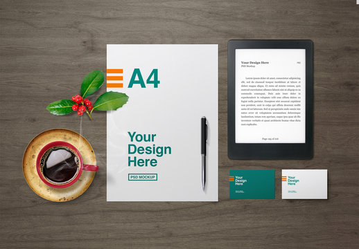 e-Reader and Stationery with Coffee Cup and Holly Decoration Mockup