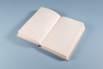 Book with a blank pages with copy space on blue background.