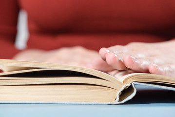 Student reading a book close up.