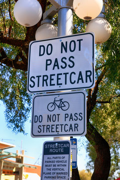 Black and white Street sign - Do Not Pass Streetcars seen on 4th Ave in Tucson AZ