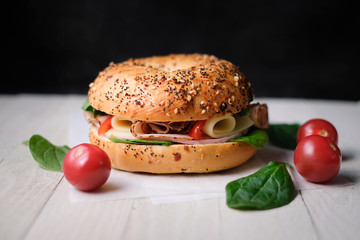 Delicious classic blt sandwiches with ham, cheese, bacon, tomatoes. Breakfast and fast food meal. on isolated black background wooden and text copy space.