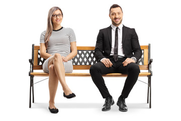 Young businessman and a blond woman sitting on a bench