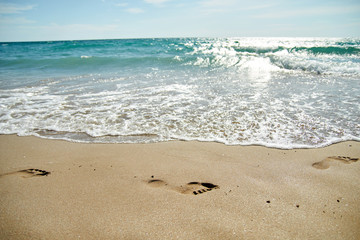 Footprint on sand at the beach. Texture background Footprints of human feet. Copy space