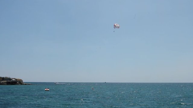 Skydiver soars over the sea