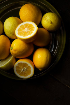 Home grown lemons on an olive green plate.