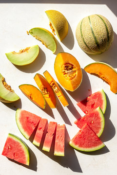 Slices of watermelon,cantaloupe and honeydew melon on the table,top view