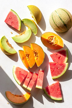 Slices of watermelon,cantaloupe and honeydew melon on the table,top view