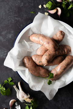Raw Angus Beef sausages seasoned with garlic and parsley.
