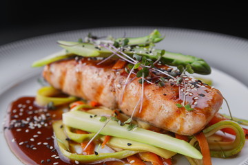 Grilled salmon steak on a white plate