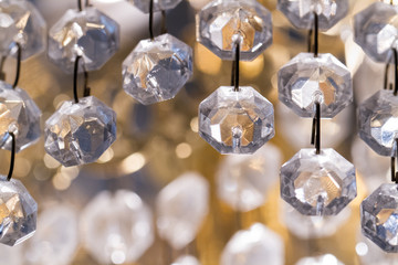 Macro closeup of string of plastic beads in a home chandelier