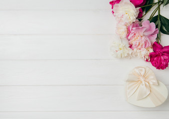 Summer subject photography. Peonies on a white board