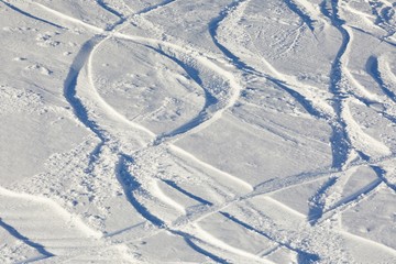 Ski and snowboard curves in the fresh snow slope