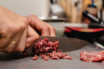 Chef preparing steak tartar of old cow sirloin with 40 days of maturation on restaurant