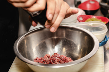 Chef preparing steak tartar of old cow sirloin with 40 days of maturation on restaurant