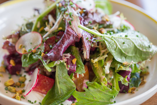 Drop the Beet: fire roasted beets, goat cheese labneh, sumac marinated onions, frisse, pk farm greens, roasted pistachio