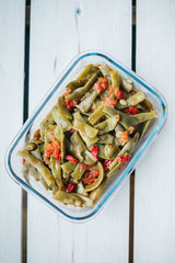 Turkish traditional Fresh Beans food on  glass plate. Green beans olive oil whiteboard on the floor