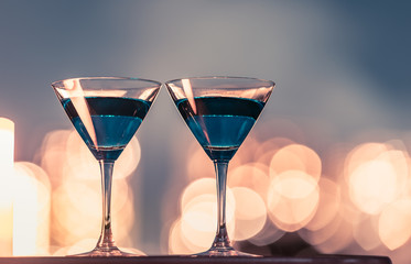 Martini glasses on a bar. City night life concept. 