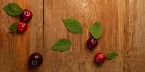 Plums on wooden table. Top view.