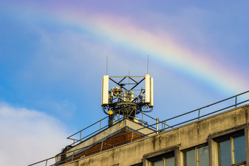 A rainbow over a phone mast