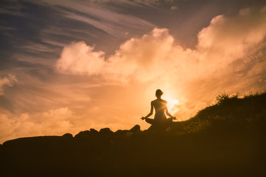 Meditation on a mountain at sunrise 