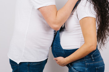 Cropped image of beautiful pregnant woman and her handsome husband holding