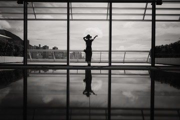 Fototapeta premium Woman stand in front of windows