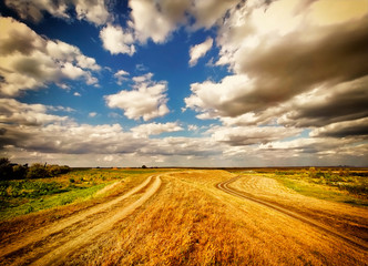 Country dirt road and blue sky