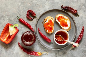 chili jam from chili pepper and paprika. fried toasts, soft (goat) cheese and chili jam. hot jam...