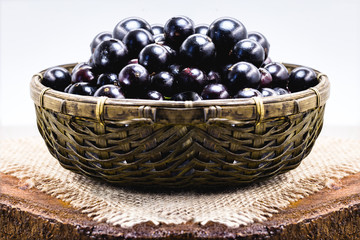Fruit called Jaboticaba or jabuticaba in a basket on a white background, preserves organic and healthy fruits.